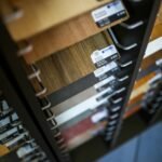 Close-up of various laminated wood veneer samples in a showroom display rack.